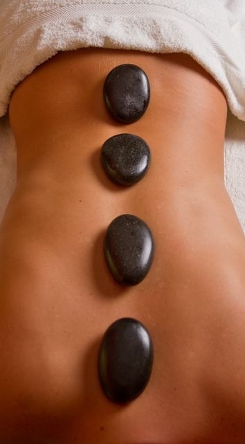 Legs massage with hot stones